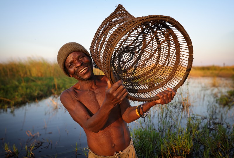 Malawi, fisherman with fish trap